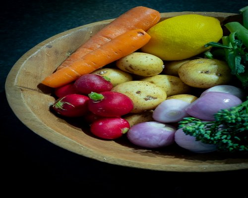 A variety of fresh, colorful vegetables and fruits in bowls